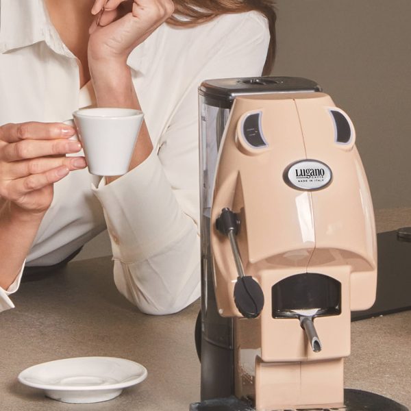 An Italina women drinking an esspreso cup prepared by Lugano Uno Baby espresso Machine in an elite pose